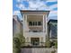 Stunning exterior elevation featuring a stucco facade, black accents, and a charming balcony at 81 Delmont Ne Dr, Atlanta, GA 30305