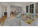 Bright and airy living room with a large rug, comfortable seating, and a view of the dining area at 81 Delmont Ne Dr, Atlanta, GA 30305