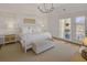 Airy bedroom featuring a large bed, neutral colors, and access to an outdoor balcony at 81 Delmont Ne Dr, Atlanta, GA 30305