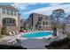 Community pool surrounded by comfortable lounge chairs and well-manicured greenery at 81 Delmont Ne Dr, Atlanta, GA 30305