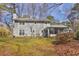 Back view of home with sunroom, mature trees, and spacious yard at 2113 N Landing Way, Marietta, GA 30066