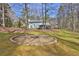 Spacious backyard featuring a unique fire pit and mature trees at 2113 N Landing Way, Marietta, GA 30066