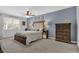 Spacious primary bedroom with a large window, complemented by an elegant dresser at 2113 N Landing Way, Marietta, GA 30066