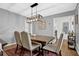 Dining room features a wood table with upholstered chairs and a modern light fixture at 2113 N Landing Way, Marietta, GA 30066