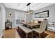 Dining room with wood table, upholstered chairs, a bench, rug, modern light fixture, and large window at 2113 N Landing Way, Marietta, GA 30066