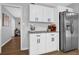 Kitchen area features stainless steel refrigerator, white cabinets, and granite countertops at 2113 N Landing Way, Marietta, GA 30066