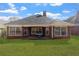 Exterior showing a well-maintained backyard, brick facade, and modern windows at 2201 Chase Se Way, Conyers, GA 30013