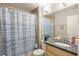 Bathroom featuring a vanity with blue striped shower curtain and a combination shower and tub at 30 Finch Ne Trl, Atlanta, GA 30308