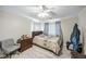 Bedroom featuring a ceiling fan, a comfortable bed, a closet, and natural light through the window at 30 Finch Ne Trl, Atlanta, GA 30308