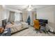 Bedroom featuring a ceiling fan, a comfortable bed, a desk area, and natural light through the window at 30 Finch Ne Trl, Atlanta, GA 30308