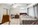 Bedroom featuring a ceiling fan, a comfortable bed, a closet, and natural light through the window at 30 Finch Ne Trl, Atlanta, GA 30308