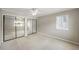 Bedroom with neutral paint, carpet, ceiling fan, and closet with mirrored doors at 30 Finch Ne Trl, Atlanta, GA 30308