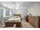 Bedroom featuring a ceiling fan, a comfortable bed, a desk area, and natural light through the window at 30 Finch Ne Trl, Atlanta, GA 30308