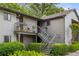 A lovely condo with a charming gray exterior, complete with a balcony, metal stairs, and lush landscaping at 30 Finch Ne Trl, Atlanta, GA 30308