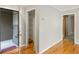 Hallway featuring hardwood floors, closet, and doorways to other rooms; neutral color palette at 30 Finch Ne Trl, Atlanta, GA 30308