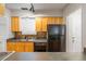 Functional kitchen featuring wood cabinets, black appliances, and ample counter space at 30 Finch Ne Trl, Atlanta, GA 30308