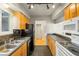 Spacious kitchen showcasing wood cabinets, black appliances, and tiled floors at 30 Finch Ne Trl, Atlanta, GA 30308
