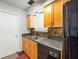 Functional kitchen featuring wood cabinets, black appliances, and ample counter space at 30 Finch Ne Trl, Atlanta, GA 30308