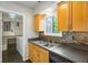 Charming kitchen featuring wood cabinets, stainless steel sink, and colorful backsplash at 30 Finch Ne Trl, Atlanta, GA 30308