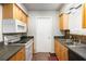 Functional kitchen featuring wood cabinets, white appliances, and ample counter space at 30 Finch Ne Trl, Atlanta, GA 30308