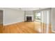 Bright living room featuring hardwood floors, fireplace, and sliding glass door to the outside at 30 Finch Ne Trl, Atlanta, GA 30308