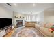 Comfortable living room with a fireplace, stylish rug, neutral sectional, and bright natural light at 30 Finch Ne Trl, Atlanta, GA 30308