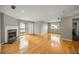 Spacious living room with hardwood floors, fireplace, and sliding door to the outdoor balcony at 30 Finch Ne Trl, Atlanta, GA 30308