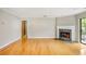 Open-concept living room featuring fireplace, hardwood floors, and outdoor access at 30 Finch Ne Trl, Atlanta, GA 30308