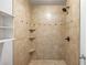 Tiled stand-up shower with shampoo nook and bronze shower head at 30 Finch Ne Trl, Atlanta, GA 30308