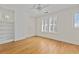 Charming bedroom featuring hardwood floors, built-in shelving, and bright windows with plantation shutters at 1446 High Point Ne Pl, Atlanta, GA 30306