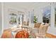 Sunlit sunroom with tile floors, rattan chairs, and a decorative rug creating a peaceful retreat at 1446 High Point Ne Pl, Atlanta, GA 30306