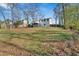 Grassy yard features a two-story house, a deck, and trees at 383 Oakridge Se Dr, Cartersville, GA 30121