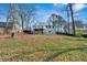 View of the rear of the two-story house with yard and trees at 383 Oakridge Se Dr, Cartersville, GA 30121