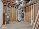 Unfinished basement with exposed pipes and water heater at 383 Oakridge Se Dr, Cartersville, GA 30121