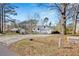 A single Gathering home with a driveway and a garage sits on a spacious property filled with trees at 383 Oakridge Se Dr, Cartersville, GA 30121