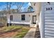 Side view of a newly renovated single-Gathering home with a modern white exterior and well-manicured front yard at 383 Oakridge Se Dr, Cartersville, GA 30121