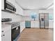 Well-lit kitchen featuring white cabinets, stainless steel appliances, and modern countertops at 383 Oakridge Se Dr, Cartersville, GA 30121