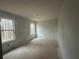 The unfinished bedroom includes two large windows, providing natural light and views at 75 Emerald Ln, Covington, GA 30014