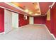 Stylish basement featuring vibrant red walls, tile flooring and recessed lighting at 918 Edgewater Dr, Loganville, GA 30052