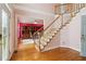 Elegant foyer featuring a staircase, hardwood floors, and bright, colorful walls at 918 Edgewater Dr, Loganville, GA 30052