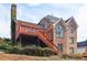 Exterior brick elevation featuring a second story deck with access to the yard at 918 Edgewater Dr, Loganville, GA 30052