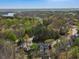 Aerial view of a stately home nestled within a wooded landscape, offering both seclusion and scenic beauty at 102 Stargaze Rdg, Canton, GA 30114