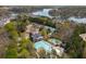 An aerial view showcasing the pool, tennis courts, clubhouse, and lake in a vibrant community setting at 102 Stargaze Rdg, Canton, GA 30114