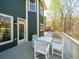 View of the back porch with table, chairs and railings overlooking a wooded area at 102 Stargaze Rdg, Canton, GA 30114