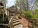 Backyard landscape with wooden stairs leading to an upper level of the yard at 102 Stargaze Rdg, Canton, GA 30114