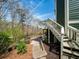 Exterior stairs leading to a walkway overlooking a scenic backyard with lush greenery and natural beauty at 102 Stargaze Rdg, Canton, GA 30114