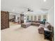 Finished basement with entertainment area, including a sectional sofa and barn door access to a play area at 102 Stargaze Rdg, Canton, GA 30114
