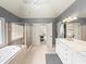 Elegant bathroom featuring a soaking tub, glass shower, and double sink vanity with granite countertops at 102 Stargaze Rdg, Canton, GA 30114