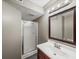 Clean bathroom with framed mirror, shower, wood vanity, and granite countertop at 102 Stargaze Rdg, Canton, GA 30114