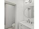 Bright bathroom features a round mirror and white marble vanity at 102 Stargaze Rdg, Canton, GA 30114